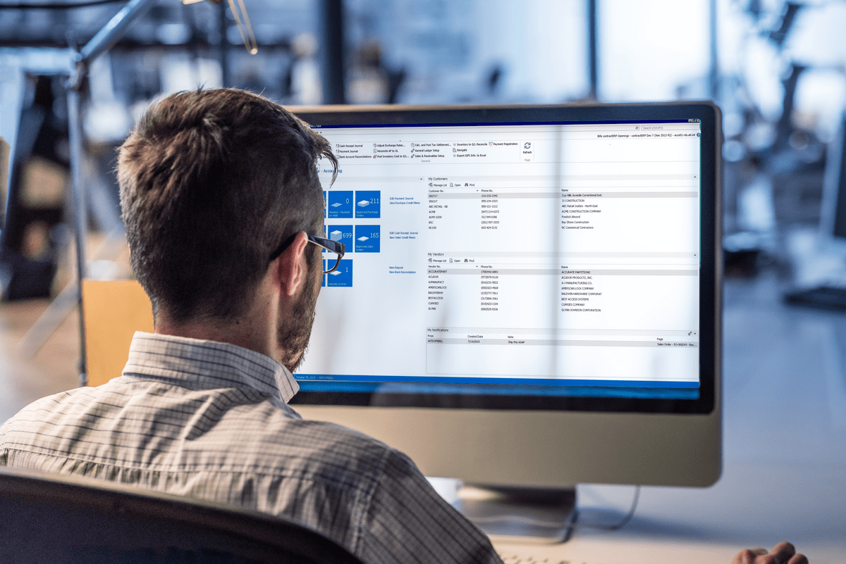 A man is working with the contractERP software.