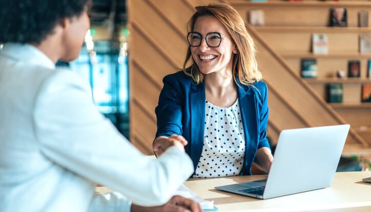 A woman and a man shake hands in a partnership