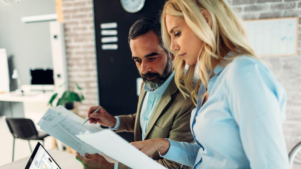 A man and woman examining paperwork