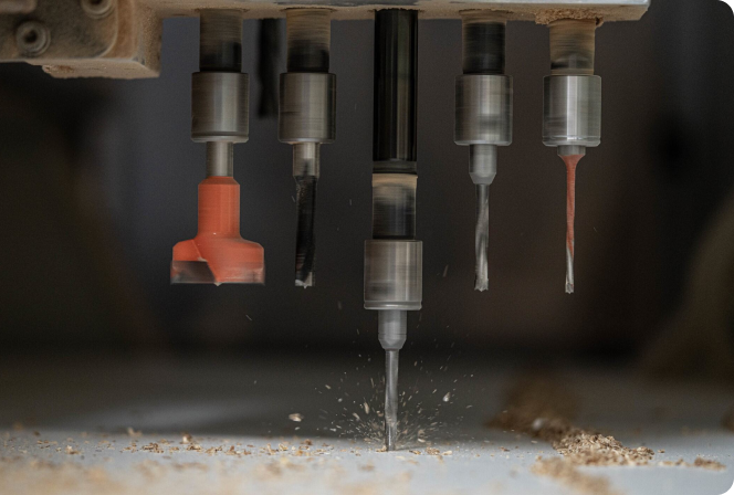 A drill is cutting through a piece of wood